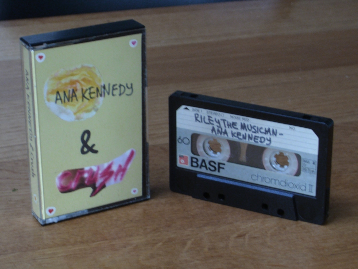 a cassette case with a handmade cover. a flower from ANA KENNEDY's cover and the wordmark from CRUSH's cover were cut out and glued onto yellow paper. small hearts are stuck in the corners.